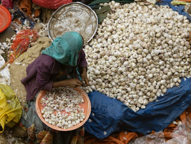 A vendor sorting produce at Merkato market in Addis Ababa, Ethiopia
